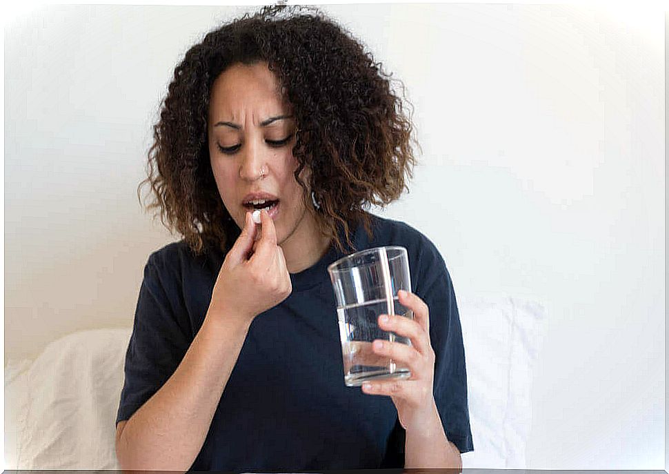 Woman swallowing a pill