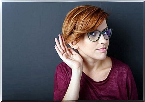 Girl with a gesture of hearing impaired