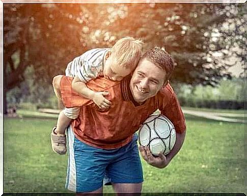 Dad carrying his son on his back